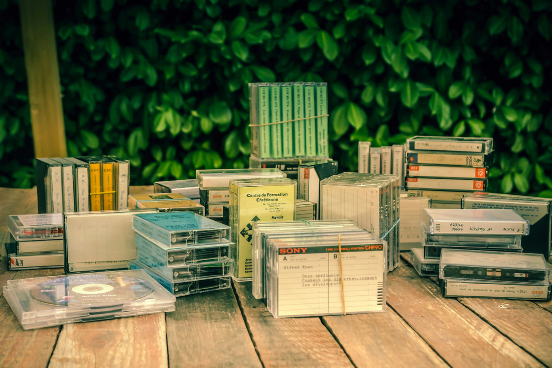 cassettes and a cd on a table outside