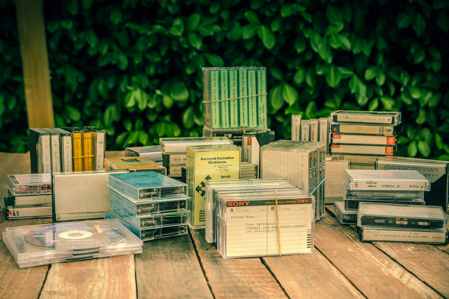 cassettes and a cd on a table outside