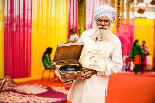 man in turban holding record