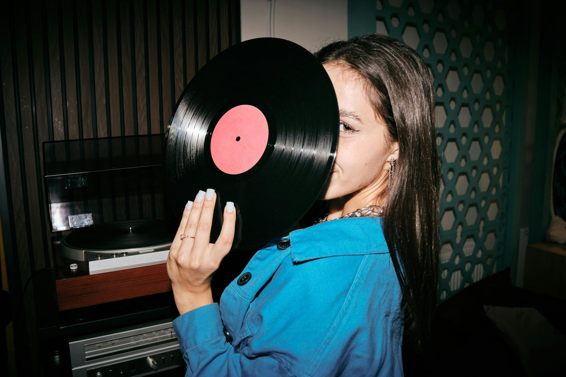 Girl Holding a Vinyl. Feature image for a blog about finding limited edition test pressings