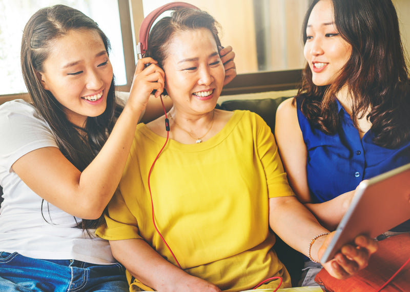 woman and daughters listening to music